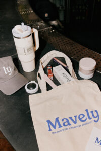 Mavely gift bag with products from e.l.f. Cosmetics, Stanley, Promix, Tarte, and Kopari